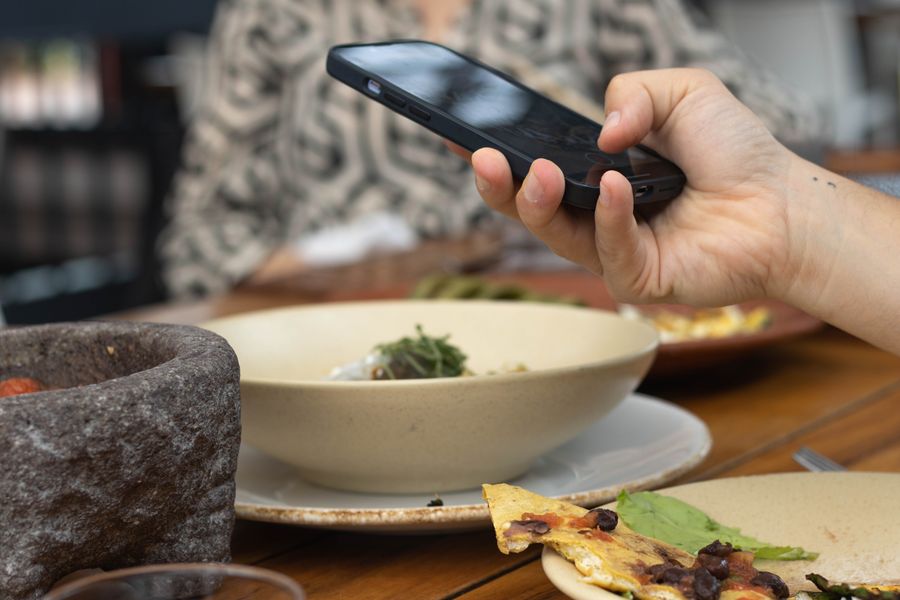 Customer photographing a meal to post about it