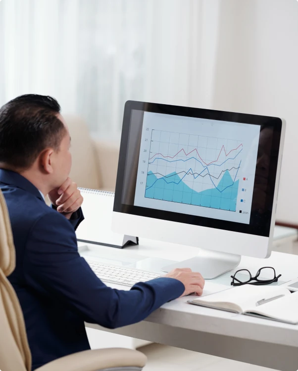 Analyst reviewing conversion trends on a desktop monitor