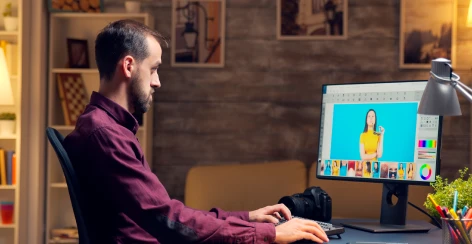 Editor retouching a portrait photo on a desktop monitor