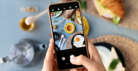 Phone photographing a breakfast table for an Instagram Story