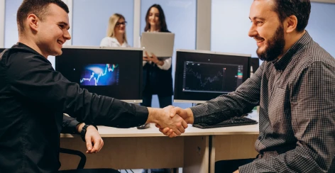Client and developer shaking hands in an office