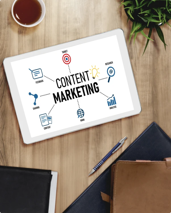 Tablet showing a content marketing diagram on a wooden desk