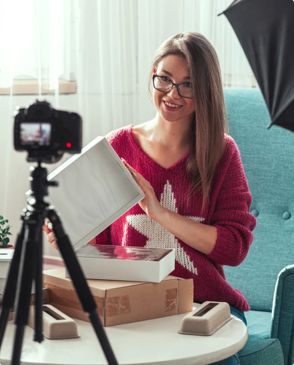 Creator filming an unboxing review on camera